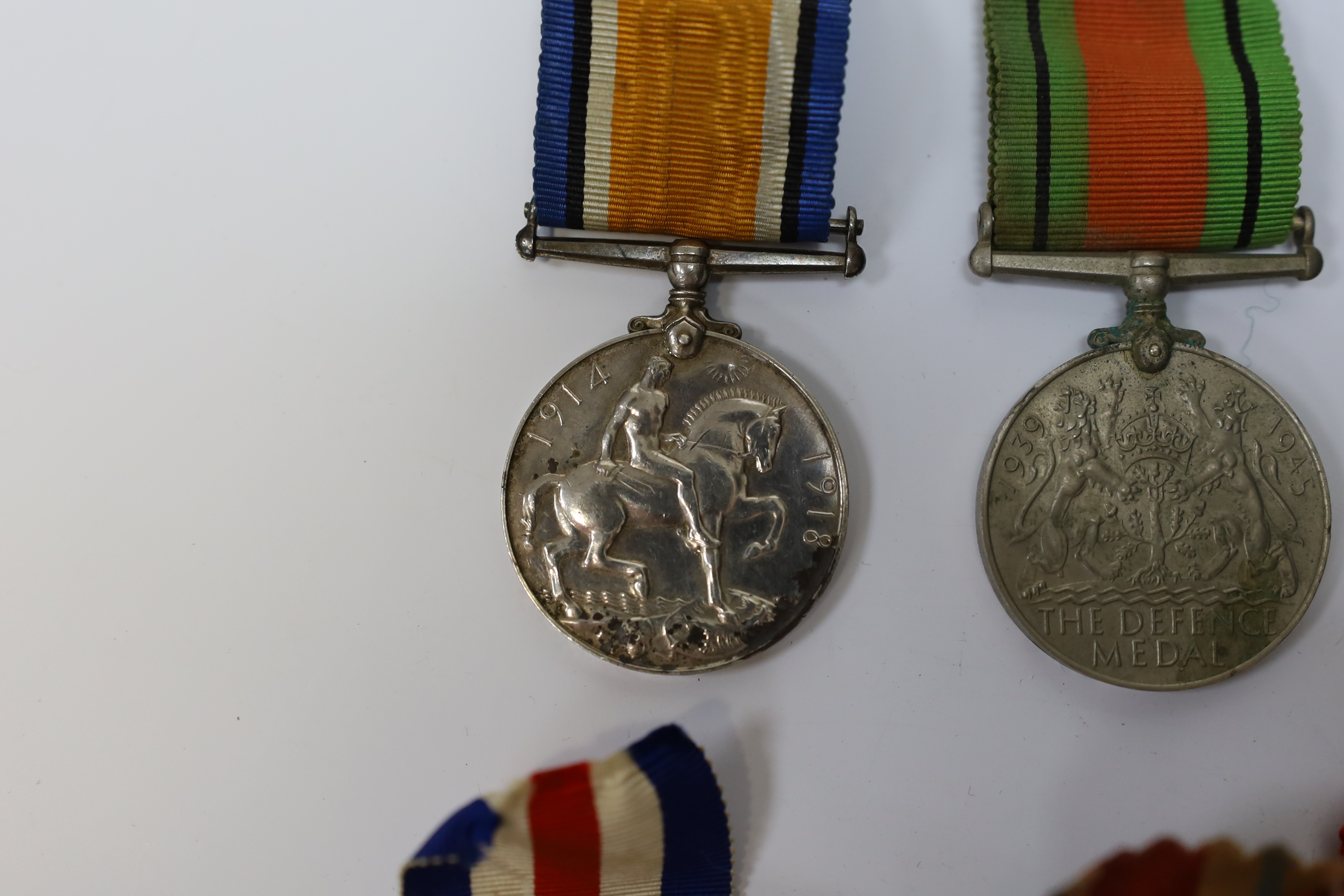 Seven medals including; a First World War British War Medal awarded to PTE. H. Lee DURH. L.I., A 1939-1945 medal, The Defence Medal, the Africa Star, the France and Germany Star, the 1939-1945 Star, plus a GPO cap badge.